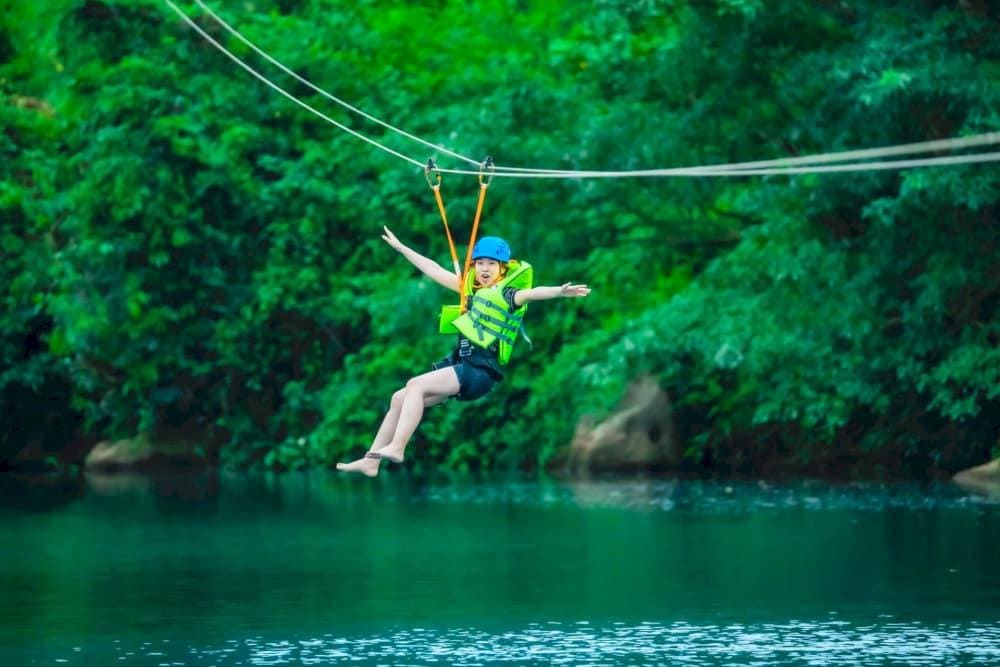 Thrilling zipline ride leading to Dark Cave's entrance is an interesting experience (Source: VietSense Travel)